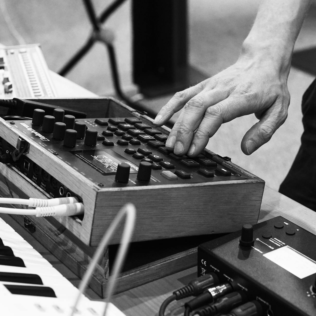 man pressing buttons on music equipment